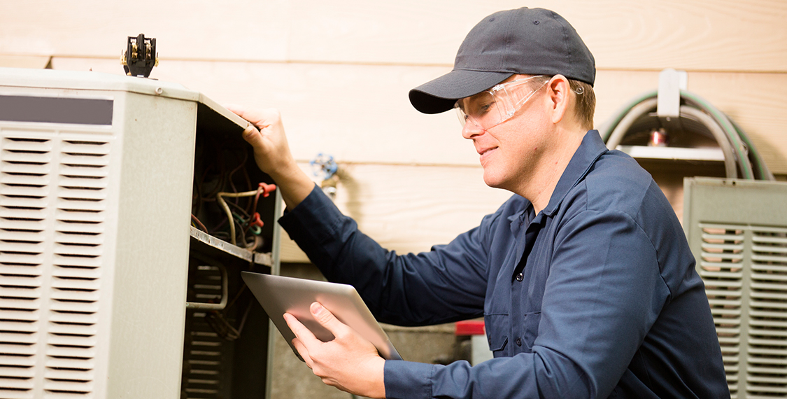 Man inspecting an HVAC unit