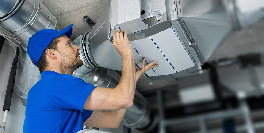 Man inspecting an air duct