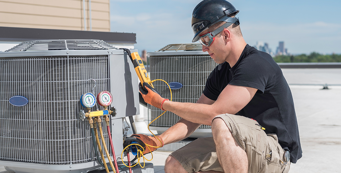Man inspecting an HVAC unit