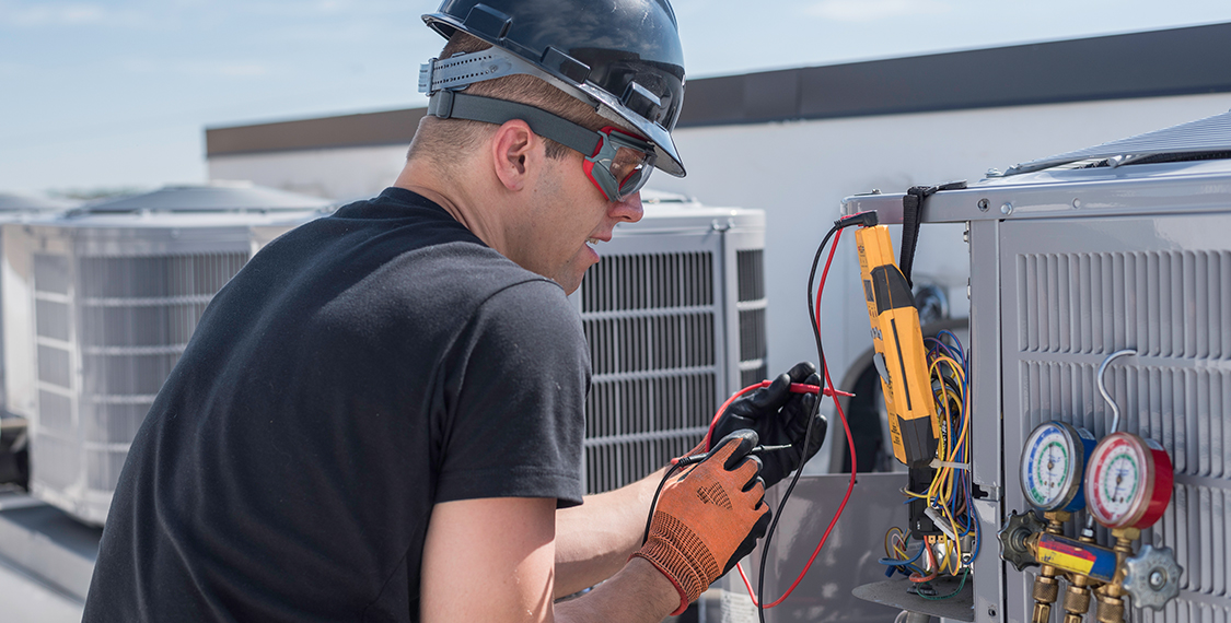 Man working on HVAC equipment