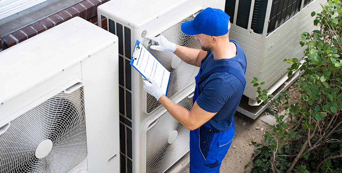 Young man checking HVAC equipment