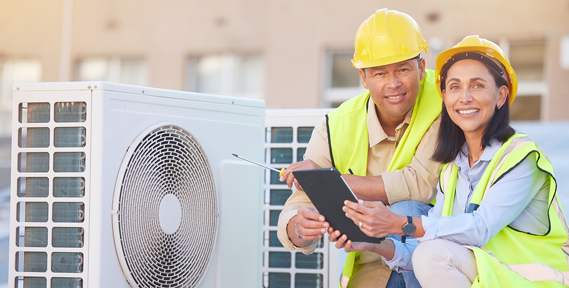 Team of workers in front of a heating system