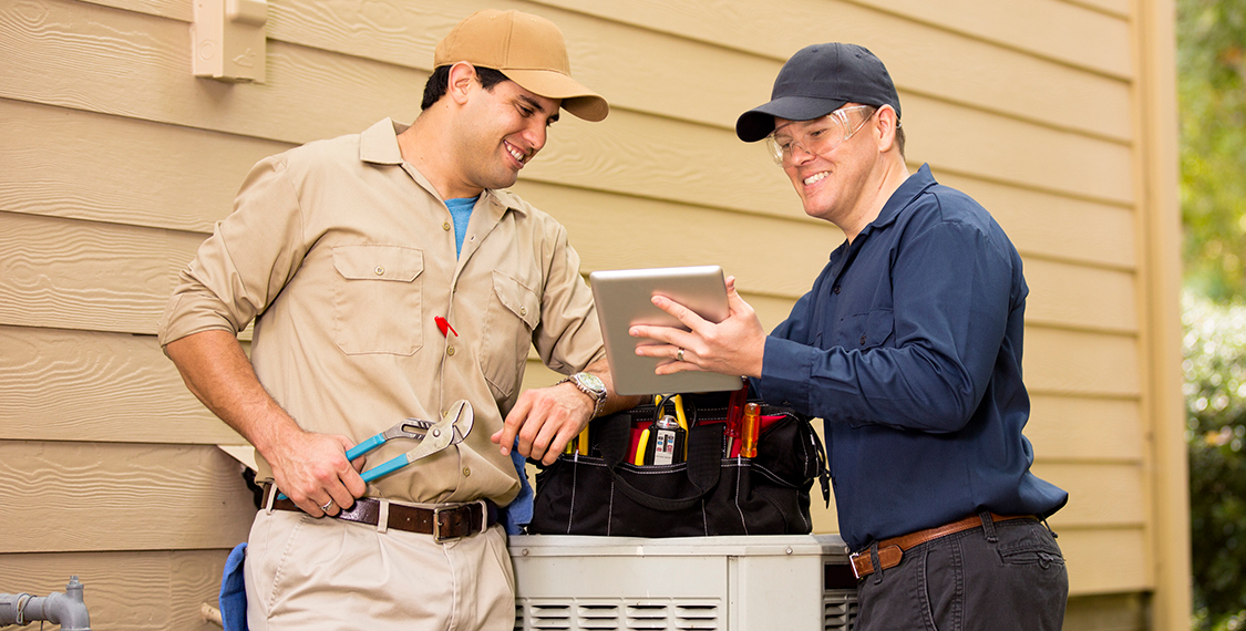Two workers looking at an ipad