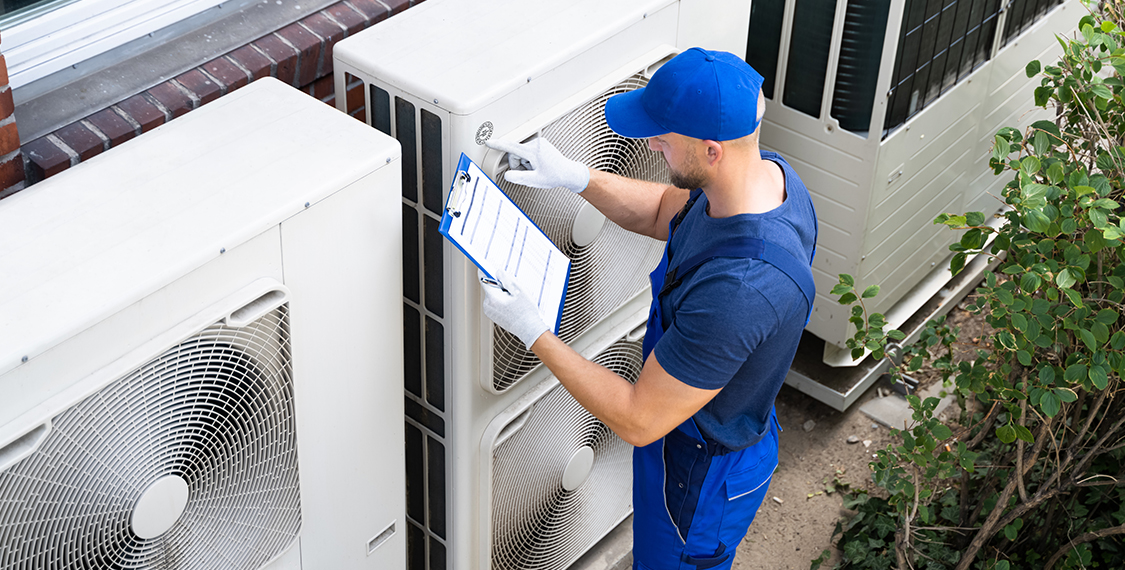 Young man checking HVAC equipment