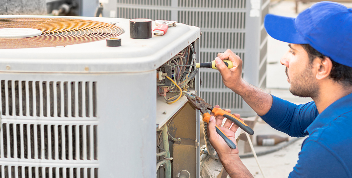 Man inspecting an HVAC system