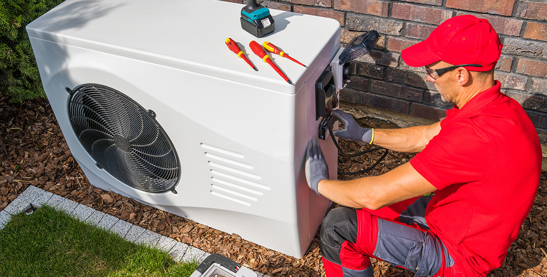 Repair man working on a heating unit