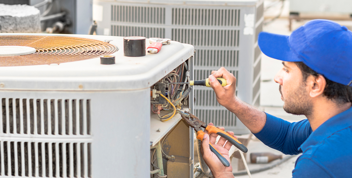 Man repairing a HVAC unit