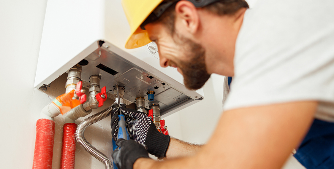 Man repairing a heat pump